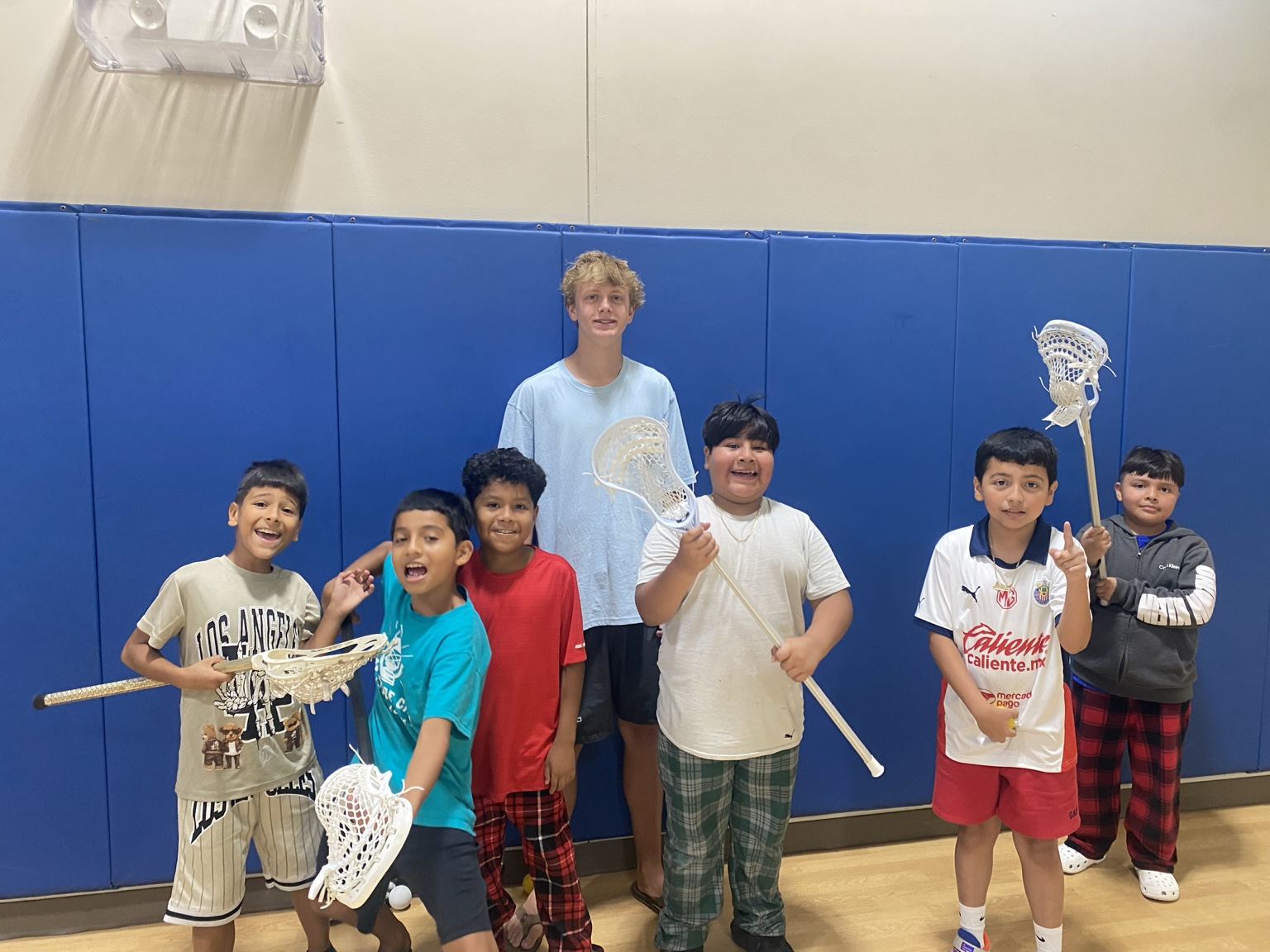 Child learning to use a lacrosse stick